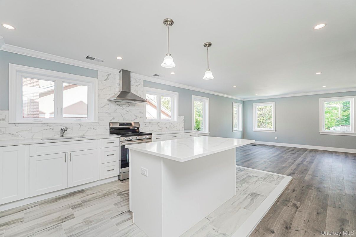 Interior, Kitchen, Marble Walls, Pendant Lights, Recessed Lighting, Stainless Steel Appliances, Wood Texture Flooring