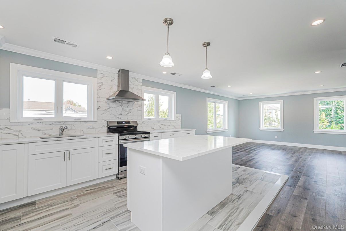 Interior, Kitchen, Marble Walls, Pendant Lights, Recessed Lighting, Stainless Steel Appliances, Wood Texture Flooring