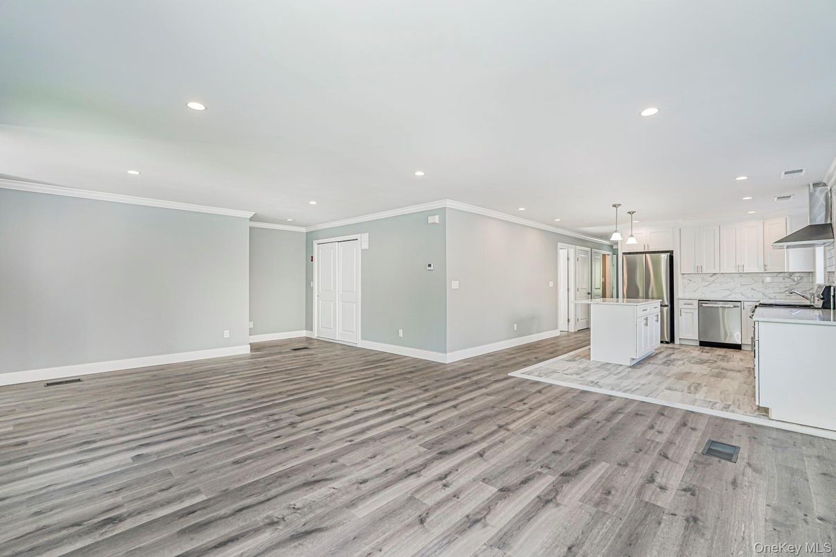 Empty room, Interior, Kitchen, Pendant Lights, Recessed Lighting, Stainless Steel Appliances, Wood Texture Flooring
