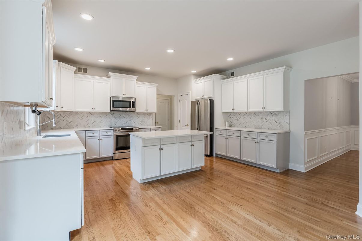 Interior, Kitchen, Marble Walls, Recessed Lighting, Stainless Steel Appliances, Wood Texture Flooring