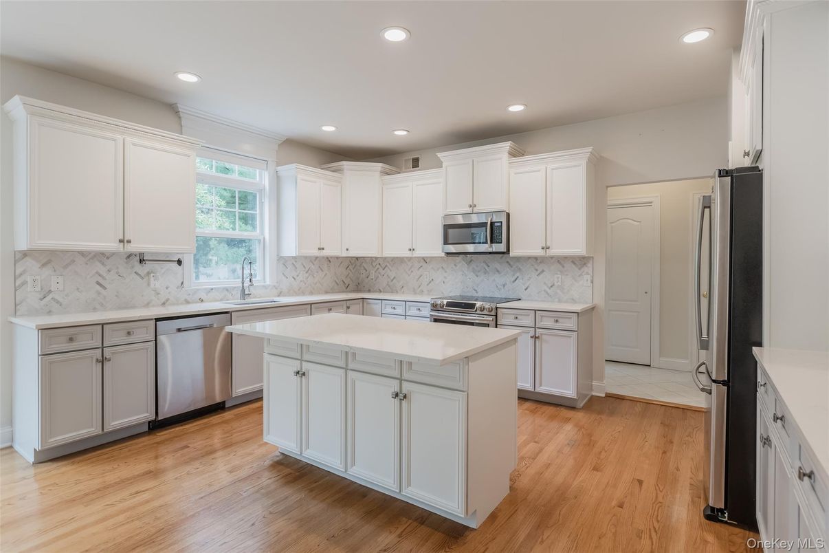 Interior, Kitchen, Marble Walls, Recessed Lighting, Stainless Steel Appliances, Wood Texture Flooring
