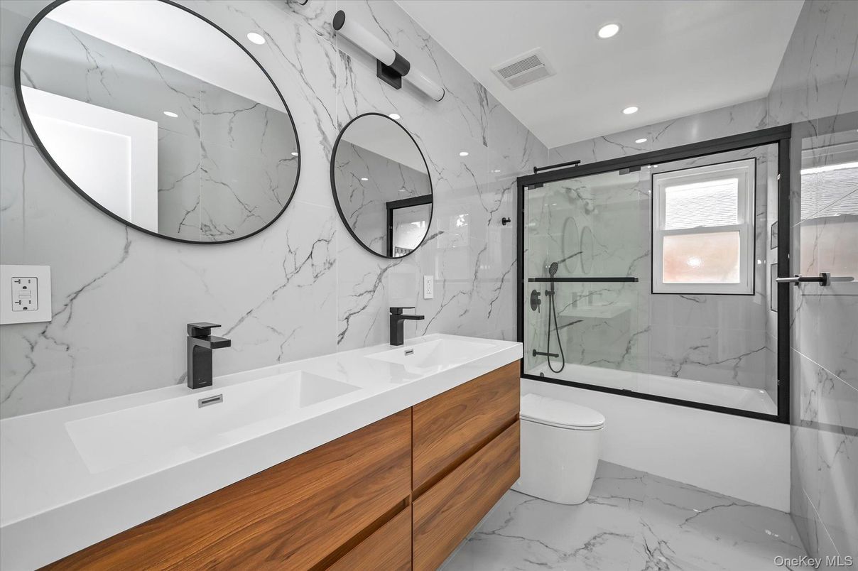 Bathroom, Dual Sink Vanities, Glass Shower, Interior, Marble, Marble Walls, Recessed Lighting