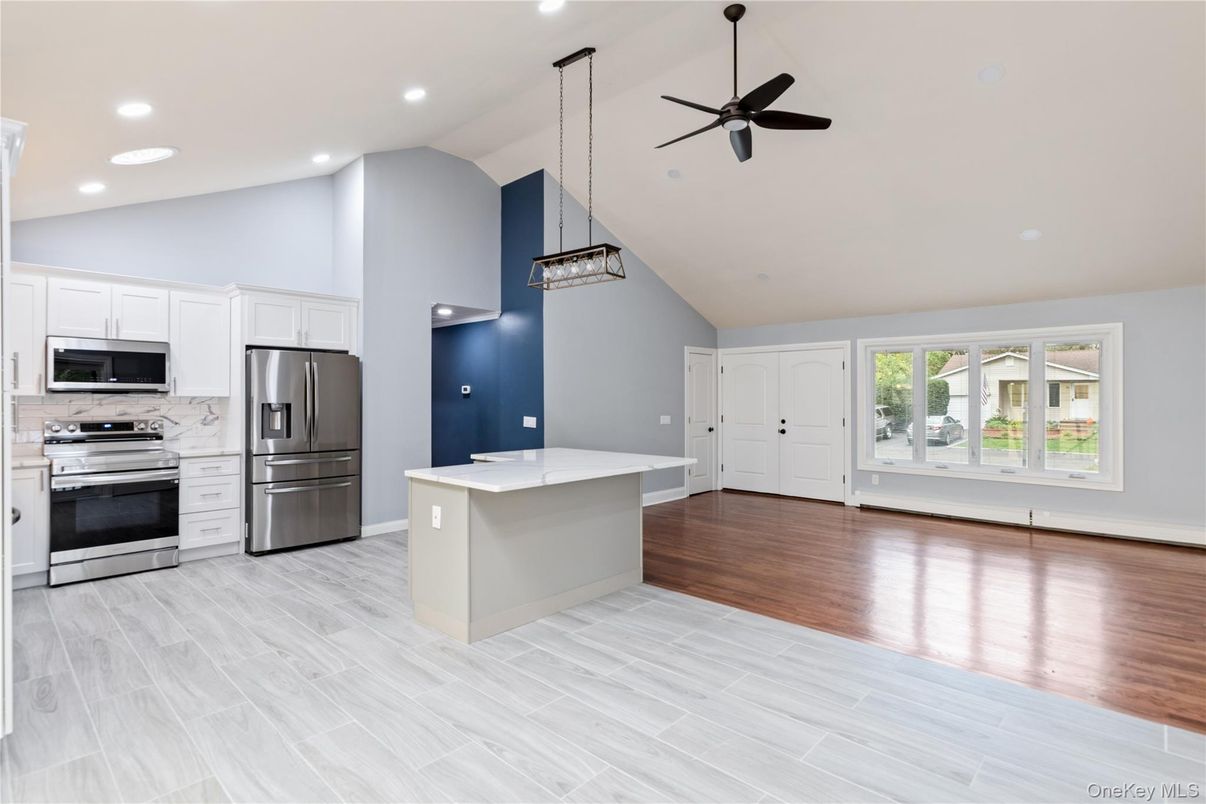Empty room, Interior, Kitchen, Pendant Lights, Recessed Lighting, Stainless Steel Appliances, Wood Texture Flooring