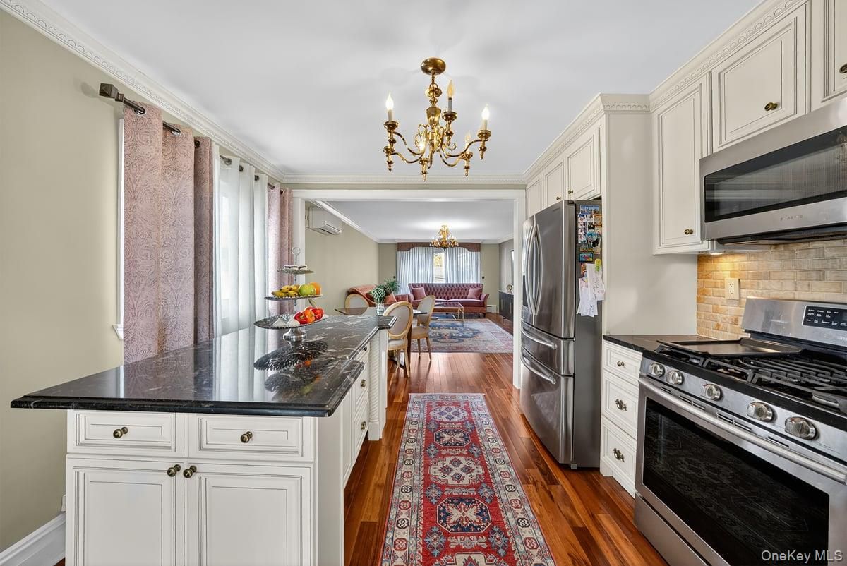 Chandelier, Dining room, Interior, Kitchen, Stainless Steel Appliances, Wood Texture Flooring