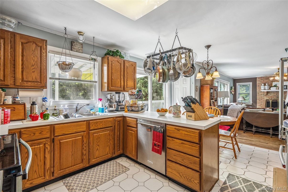 Chandelier, Dining room, Fireplace, Interior, Kitchen, Pendant Lights, Stainless Steel Appliances, Stone Walls