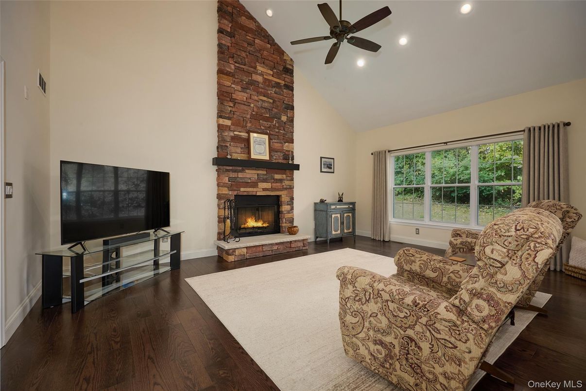 Fireplace, Interior, Living room, Recessed Lighting, Stone Walls, Wood Texture Flooring