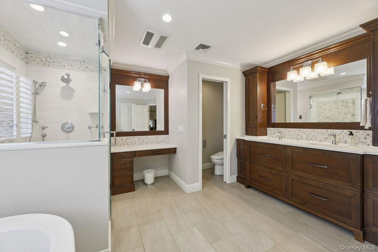 Bathroom, Dual Sink Vanities, Glass Shower, Interior, Recessed Lighting, Wood Texture Flooring