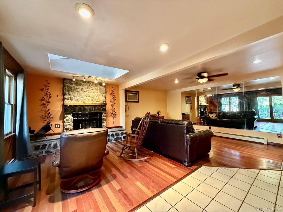 Fireplace, Interior, Living room, Recessed Lighting, Stone Walls, Wood Texture Flooring