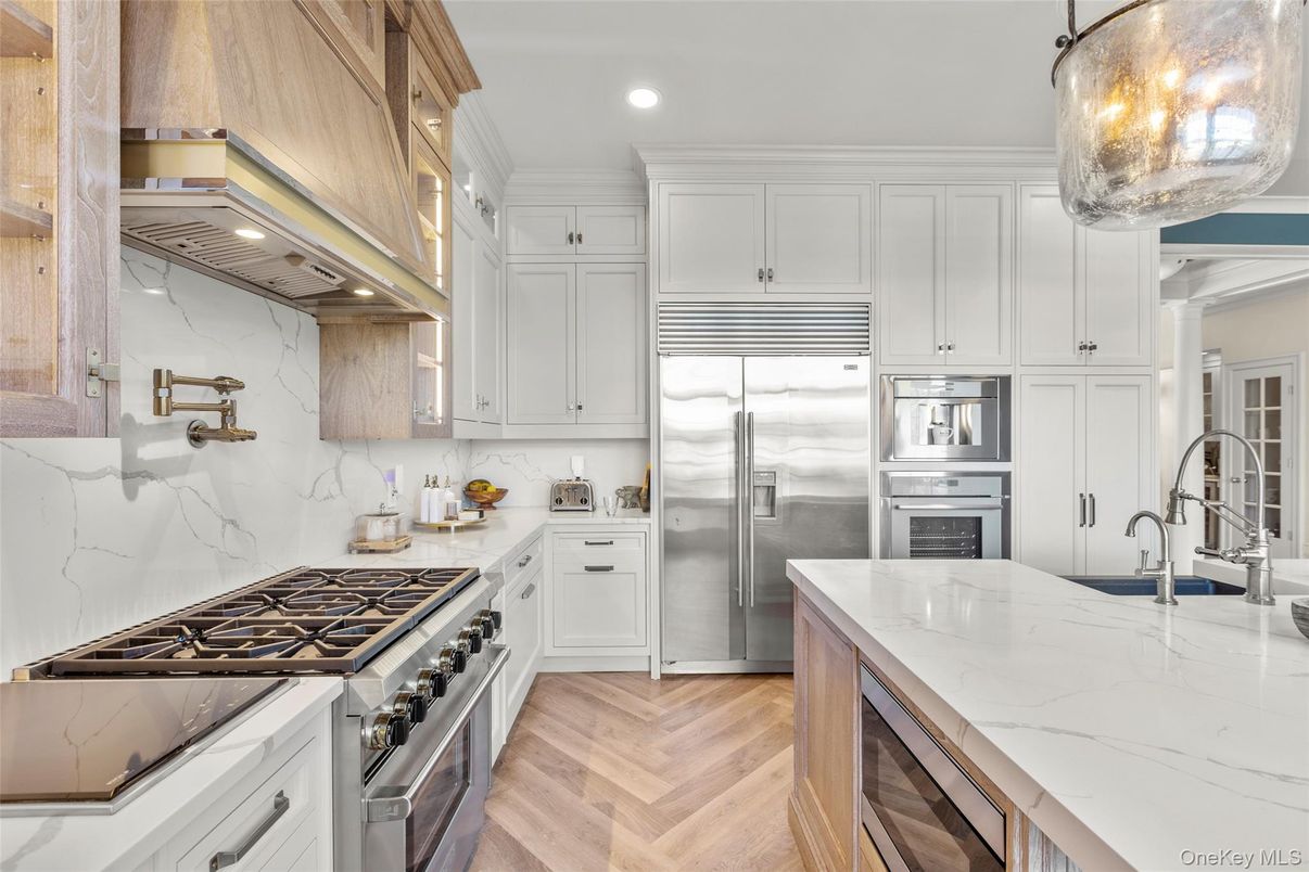Interior, Kitchen, Marble Walls, Recessed Lighting, Stainless Steel Appliances, Wood Texture Flooring