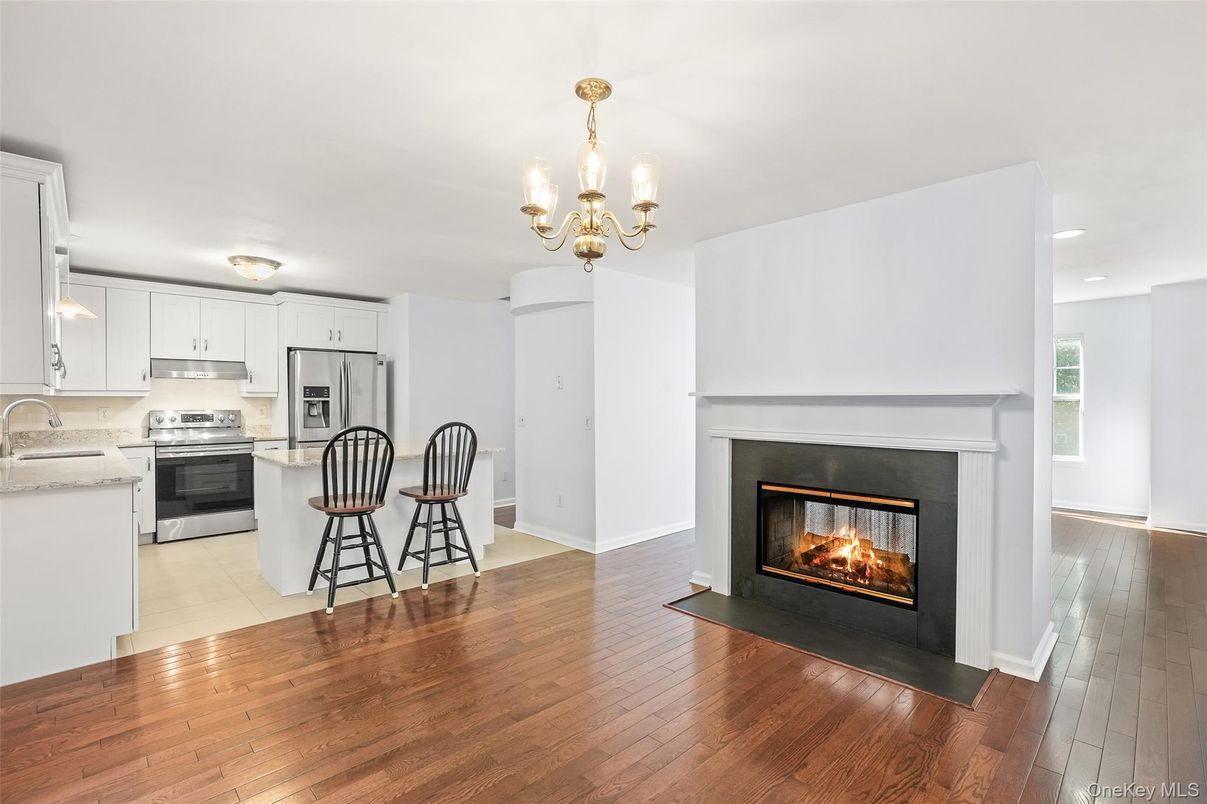 Chandelier, Fireplace, Interior, Kitchen, Recessed Lighting, Stainless Steel Appliances, Wood Texture Flooring