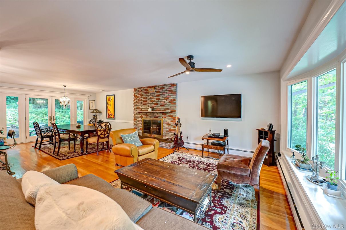 Chandelier, Dining room, Fireplace, Interior, Living room, Recessed Lighting, Stone Walls, Wood Texture Flooring
