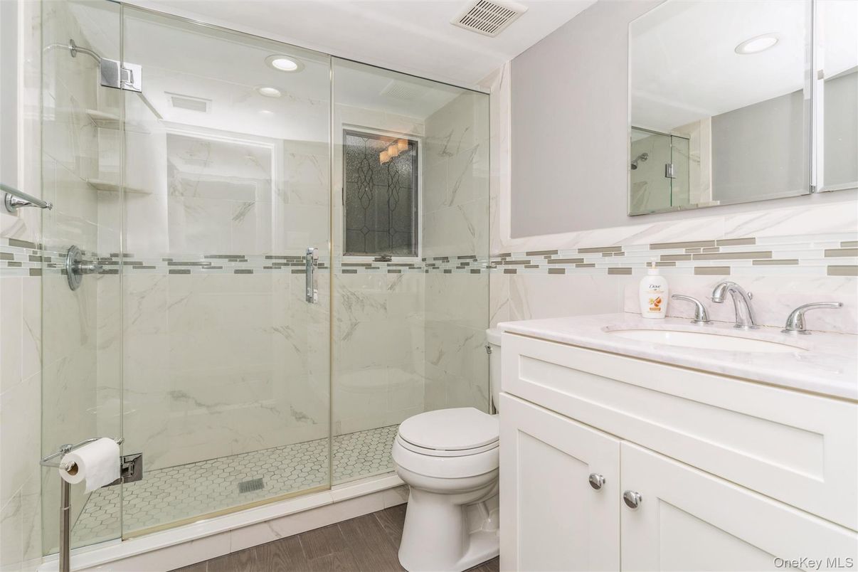 Bathroom, Glass Shower, Interior, Marble Walls, Recessed Lighting, Wood Texture Flooring