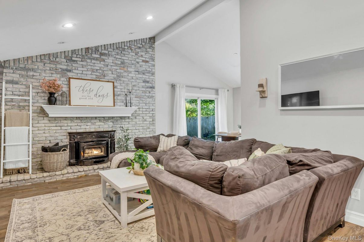 Fireplace, Interior, Living room, Recessed Lighting, Stone Walls, Wood Texture Flooring
