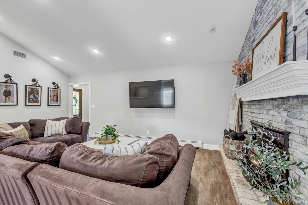 Fireplace, Interior, Living room, Recessed Lighting, Stone Walls, Wood Texture Flooring
