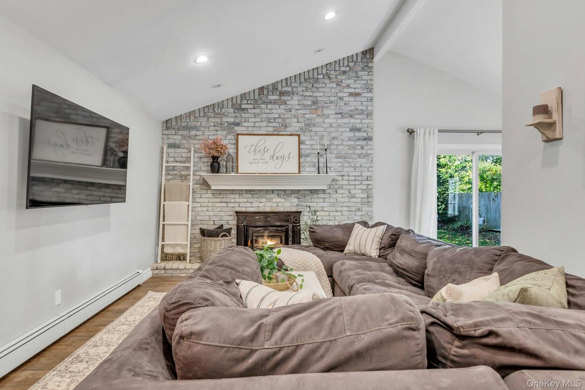 Fireplace, Interior, Living room, Recessed Lighting, Stone Walls, Wood Texture Flooring