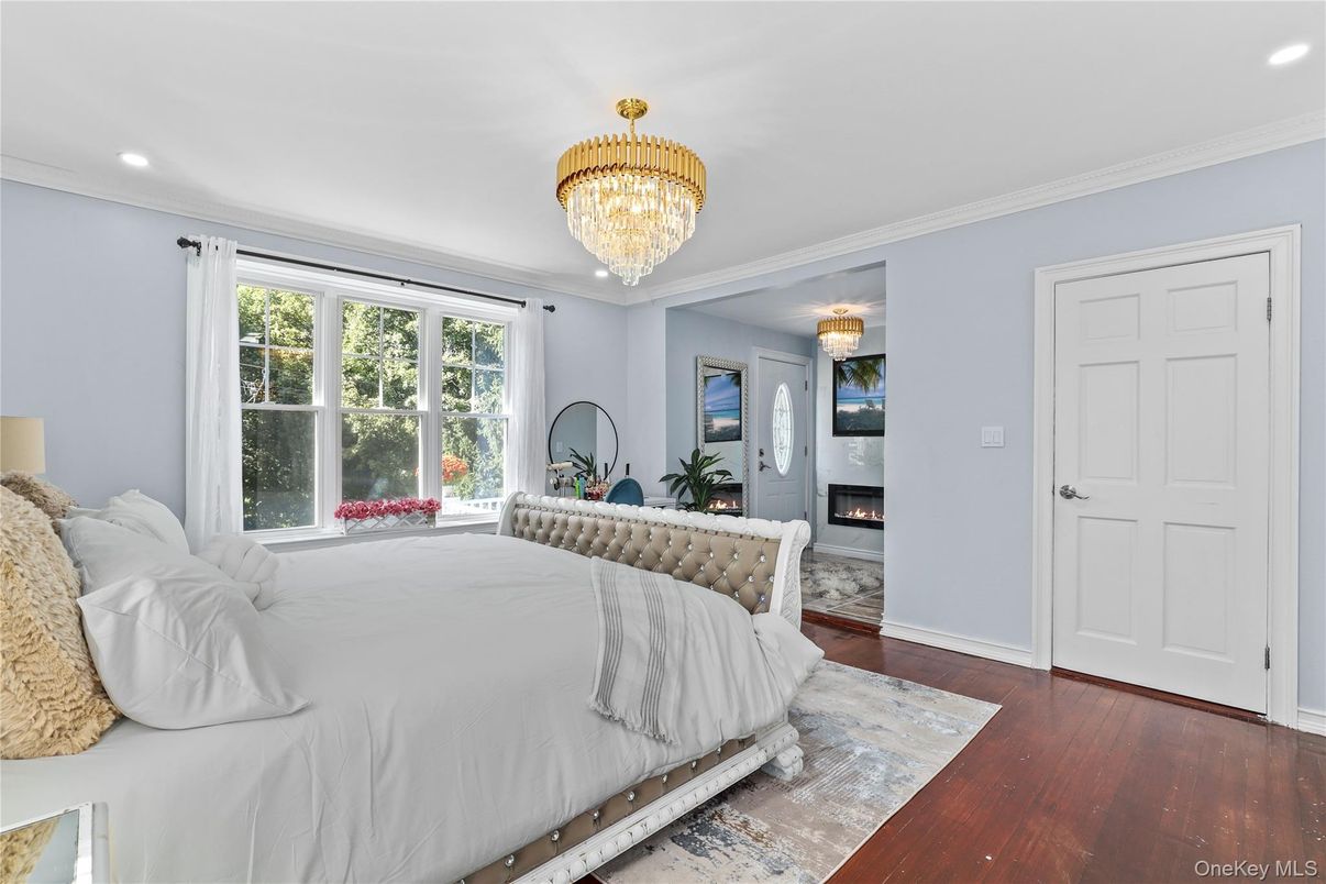 Bedroom, Chandelier, Fireplace, Interior, Recessed Lighting, Wood Texture Flooring