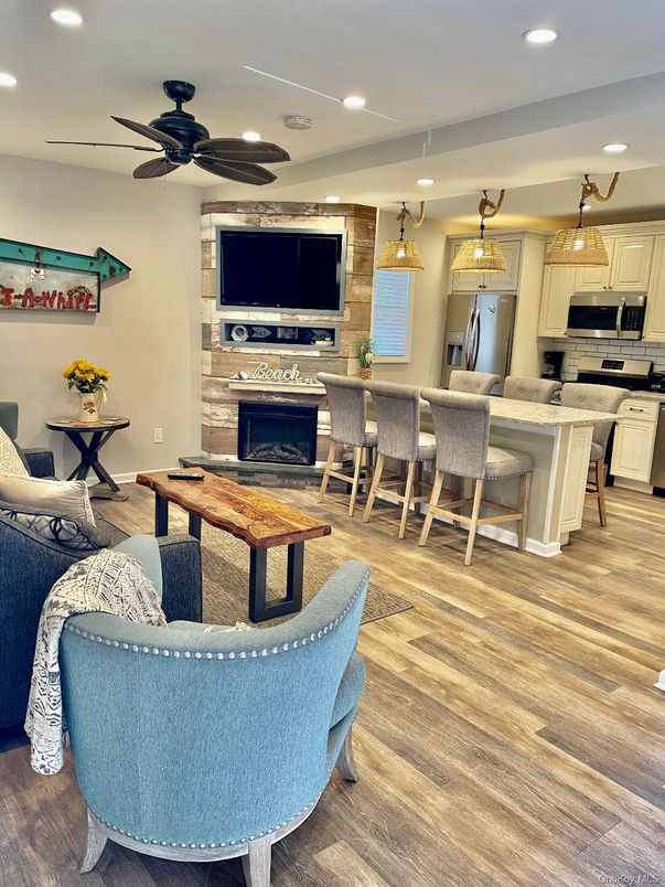 Fireplace, Interior, Kitchen, Living room, Pendant Lights, Recessed Lighting, Stainless Steel Appliances, Wood Texture Flooring