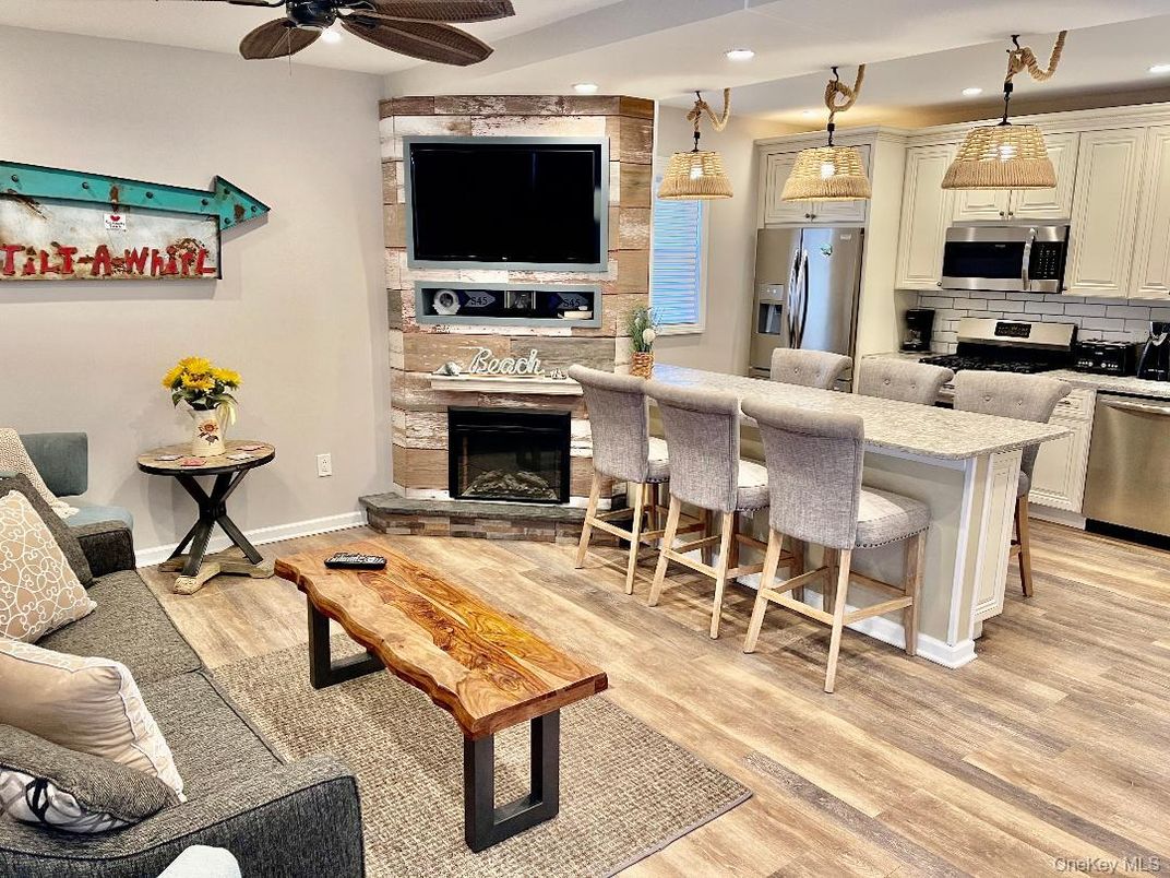 Fireplace, Interior, Kitchen, Living room, Pendant Lights, Recessed Lighting, Stainless Steel Appliances, Wood Texture Flooring