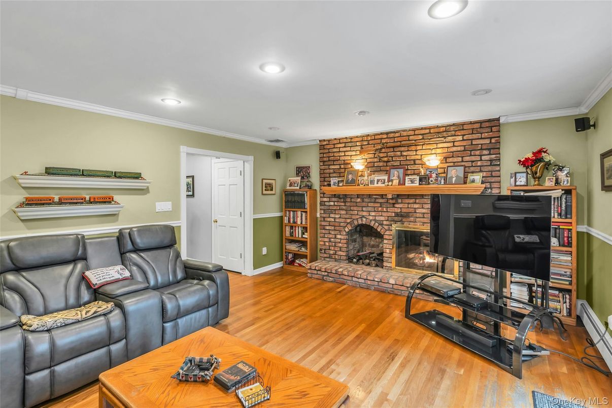 Fireplace, Interior, Living room, Recessed Lighting, Stone Walls, Wood Texture Flooring