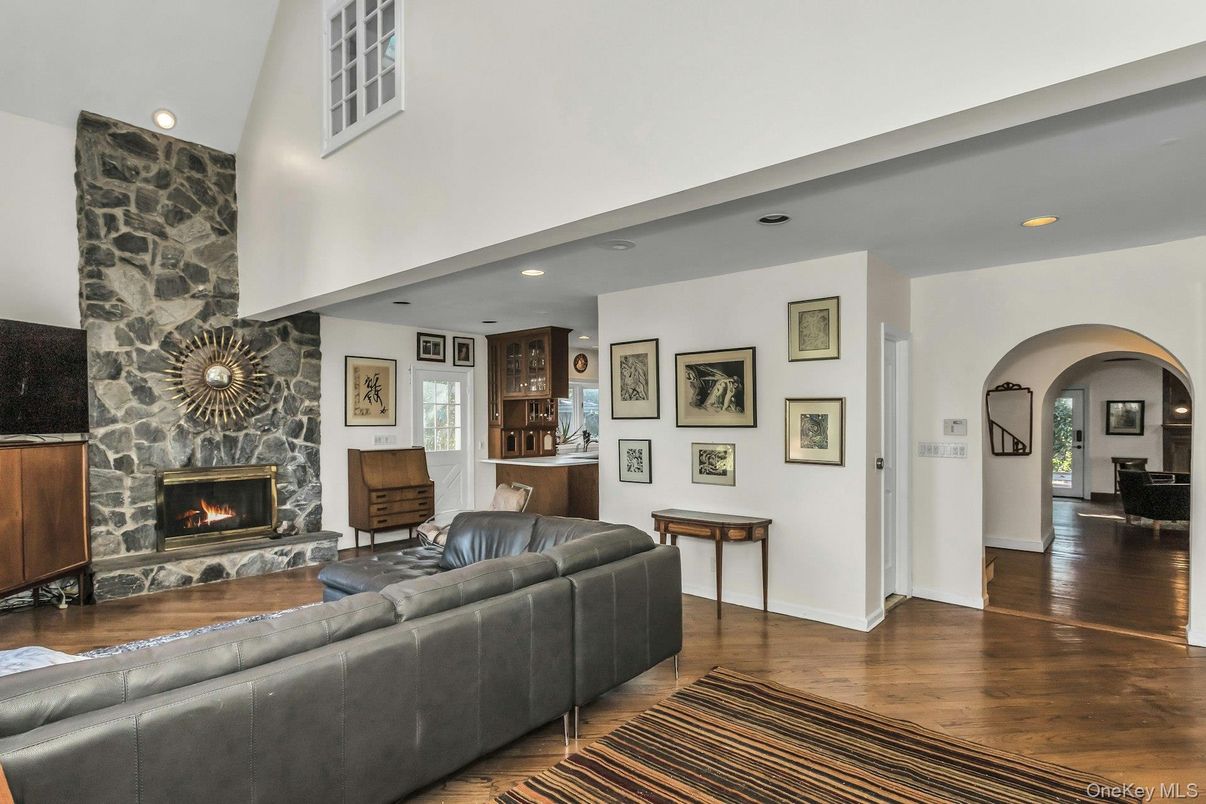 Fireplace, Interior, Living room, Recessed Lighting, Stone Walls, Wood Texture Flooring