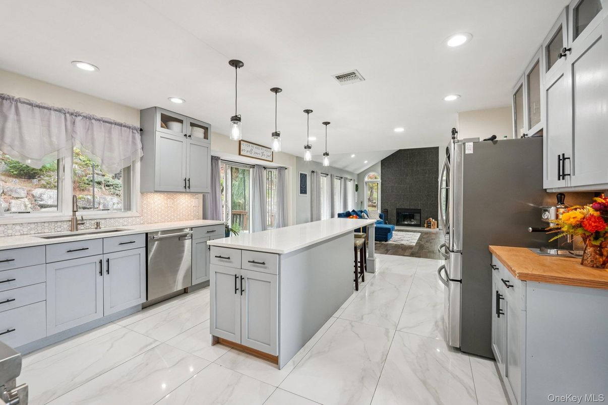 Fireplace, Interior, Kitchen, Marble, Pendant Lights, Recessed Lighting, Stainless Steel Appliances, Stone Walls