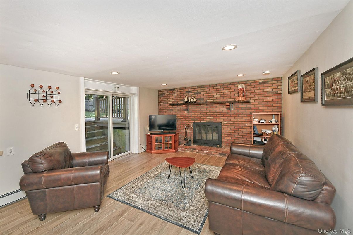 Fireplace, Interior, Living room, Recessed Lighting, Stone Walls, Wood Texture Flooring