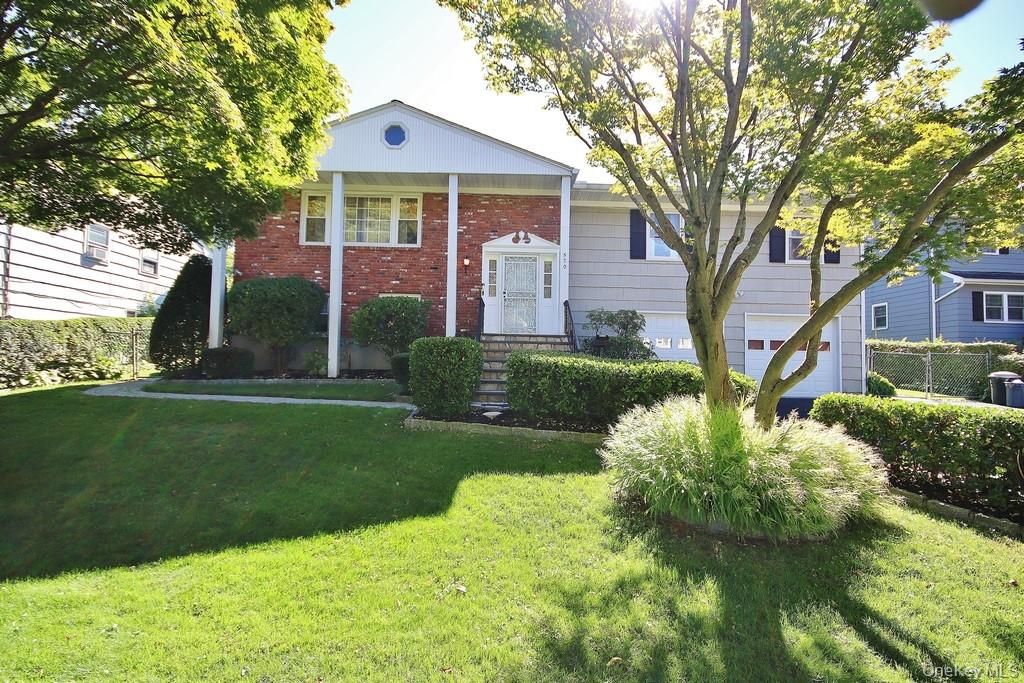 Attached, Backyard, Exterior, Facade, Brick Facade, Raised Ranch