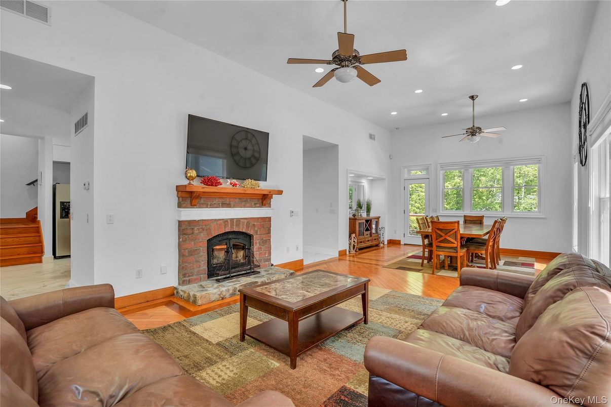 Dining room, Fireplace, Interior, Living room, Recessed Lighting, Wood Texture Flooring