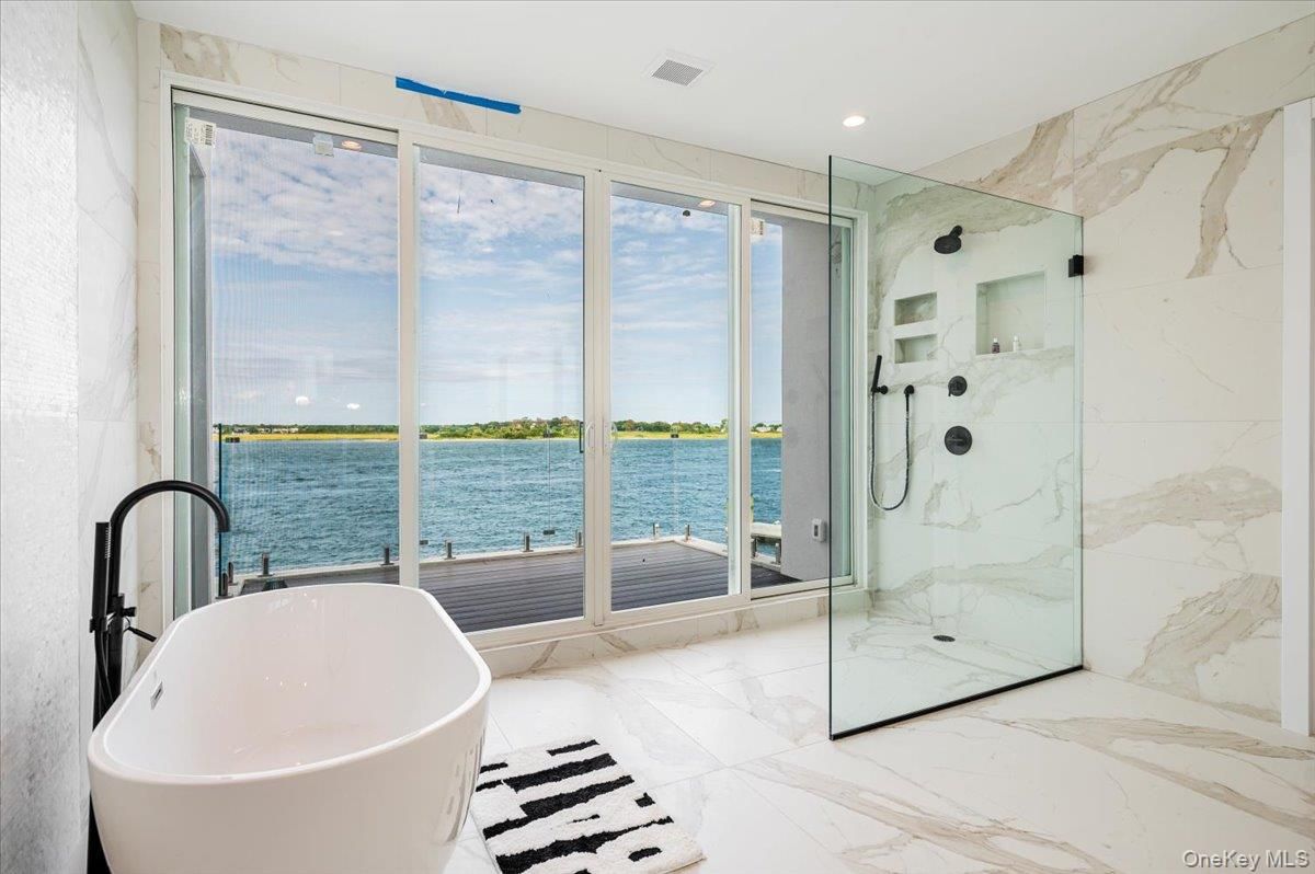 Bathroom, Free Standing Baths, Glass Shower, Interior, Marble, Marble Walls, Recessed Lighting, Water