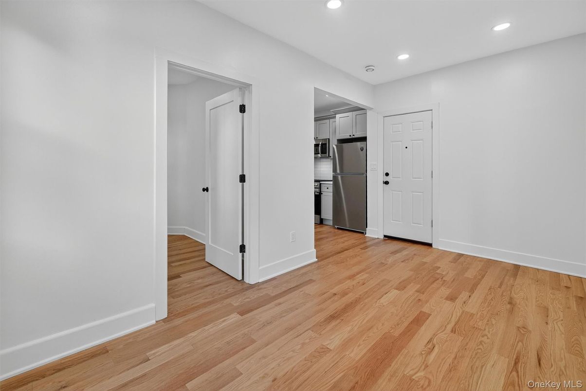 Empty room, Interior, Kitchen, Recessed Lighting, Stainless Steel Appliances, Wood Texture Flooring
