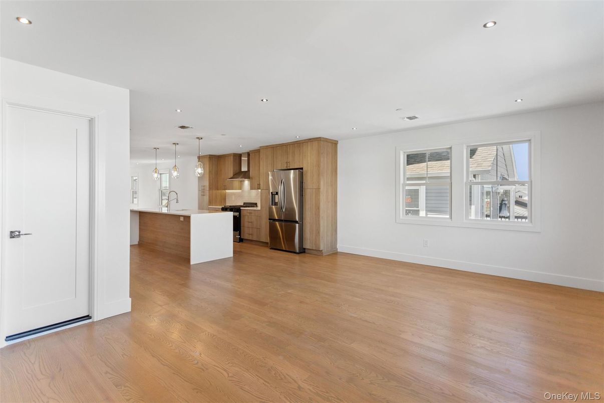 Empty room, Interior, Kitchen, Pendant Lights, Recessed Lighting, Stainless Steel Appliances, Wood Texture Flooring