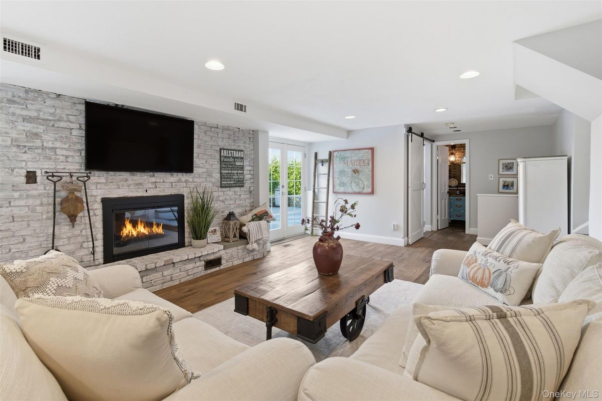 Fireplace, Interior, Living room, Recessed Lighting, Stone Walls, Wood Texture Flooring