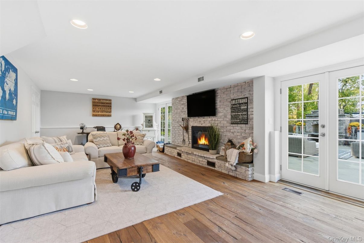 Fireplace, Interior, Living room, Recessed Lighting, Stone Walls, Wood Texture Flooring