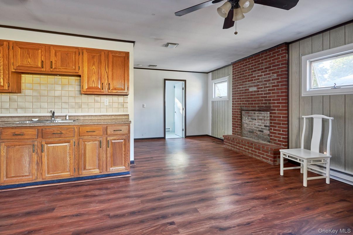 Fireplace, Interior, Kitchen, Stone Walls, Tile Countertops, Wood Texture Flooring