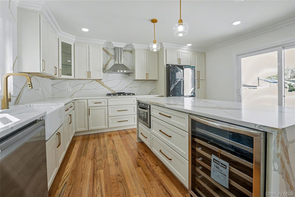 Interior, Kitchen, Marble Walls, Pendant Lights, Recessed Lighting, Stainless Steel Appliances, Wood Texture Flooring