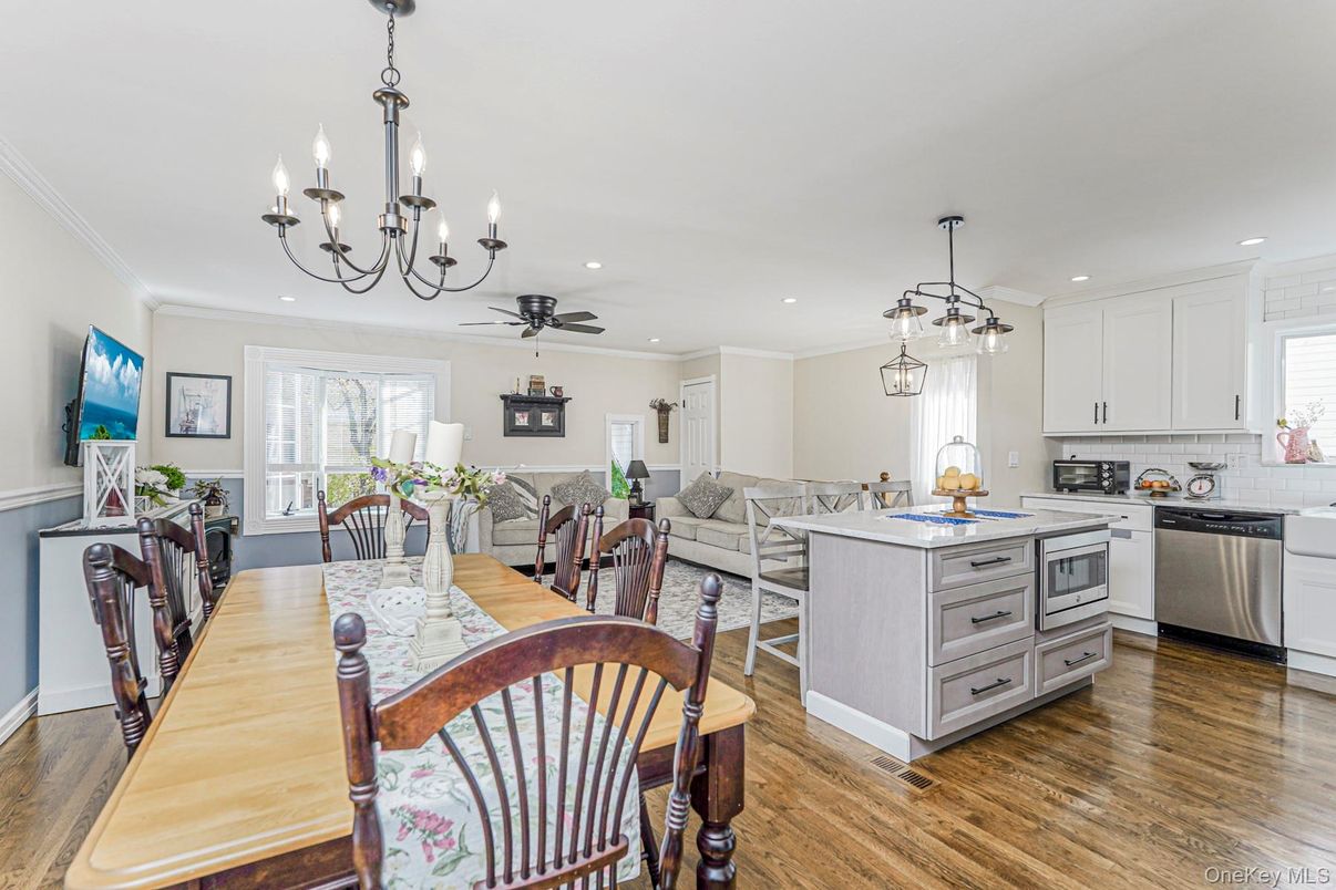 Chandelier, Dining room, Interior, Kitchen, Living room, Pendant Lights, Recessed Lighting, Stainless Steel Appliances, Wood Texture Flooring