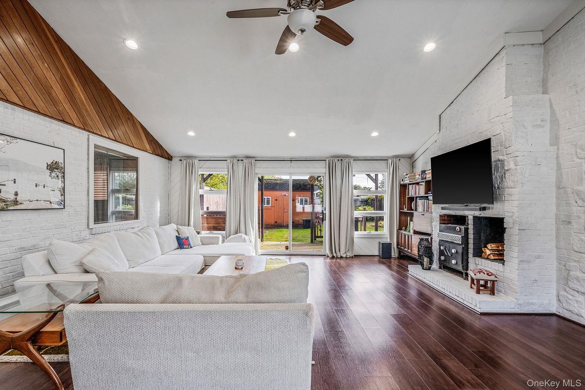 Fireplace, Interior, Living room, Recessed Lighting, Stone Walls, Wood Texture Flooring