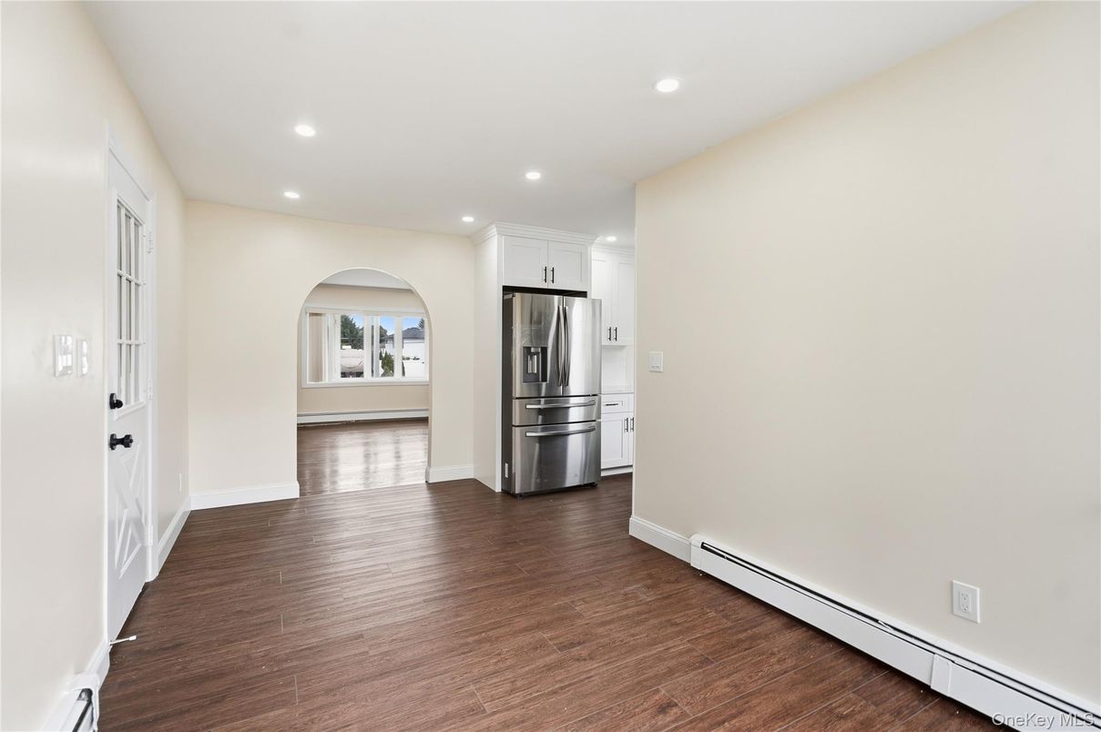 Empty room, Interior, Kitchen, Recessed Lighting, Stainless Steel Appliances, Wood Texture Flooring