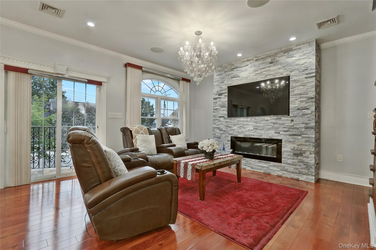 Chandelier, Fireplace, Interior, Living room, Recessed Lighting, Stone Walls, Wood Texture Flooring