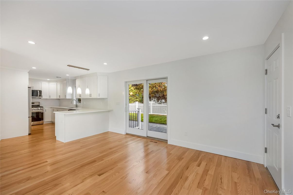 Empty room, Interior, Kitchen, Recessed Lighting, Stainless Steel Appliances, Wood Texture Flooring