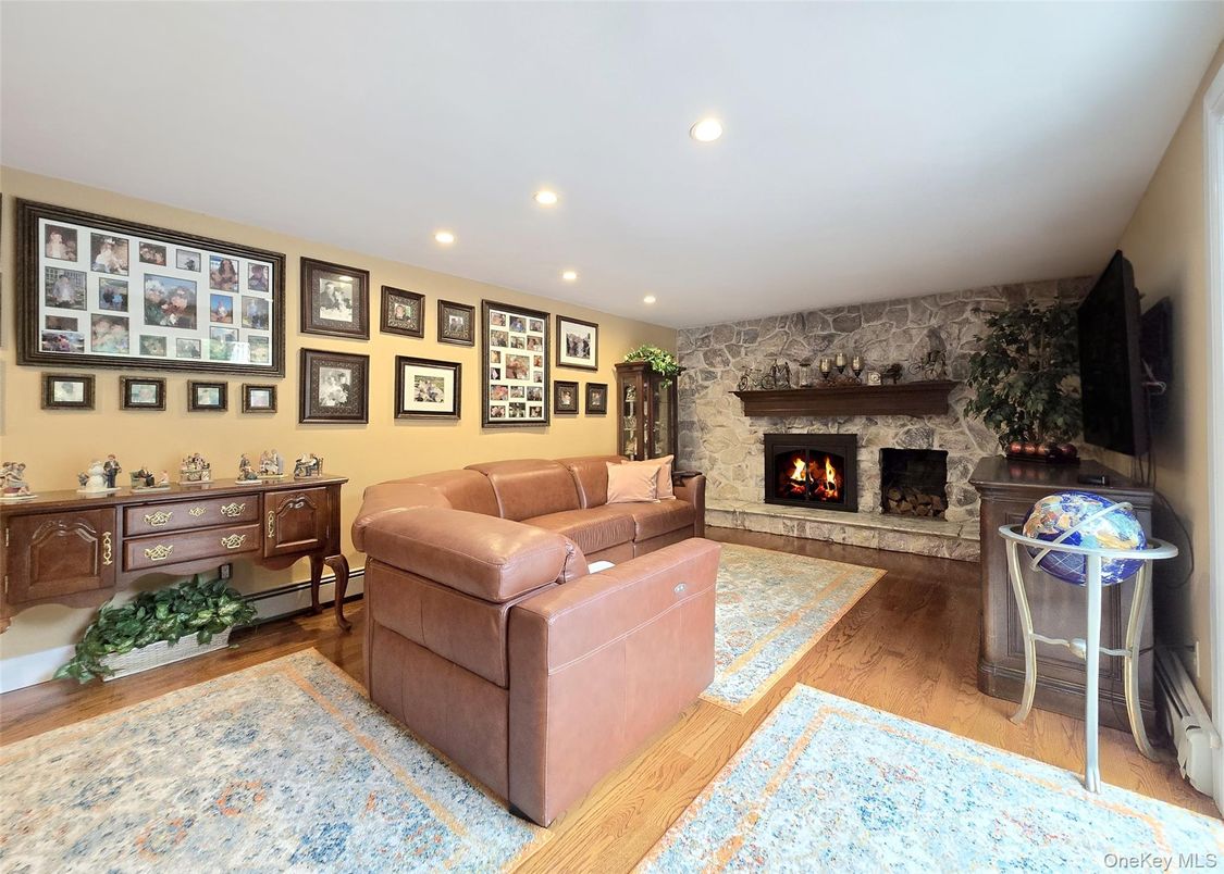 Fireplace, Interior, Living room, Recessed Lighting, Stone Walls, Wood Texture Flooring