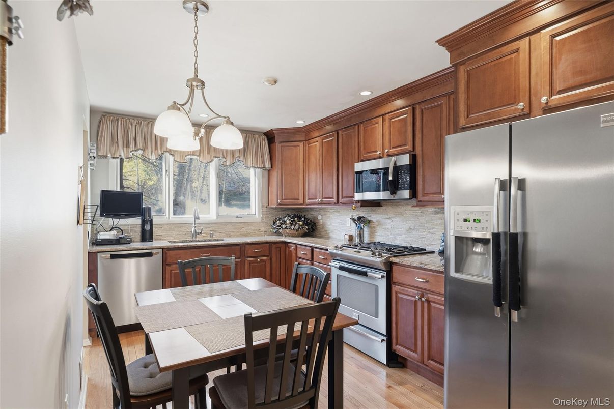 Dining room, Interior, Kitchen, Pendant Lights, Recessed Lighting, Stainless Steel Appliances, Wood Texture Flooring