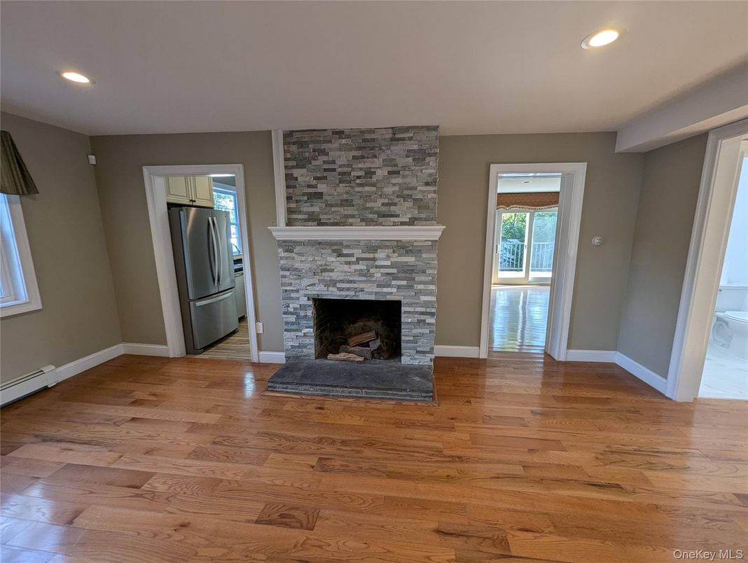 Empty room, Fireplace, Interior, Recessed Lighting, Stone Walls, Wood Texture Flooring