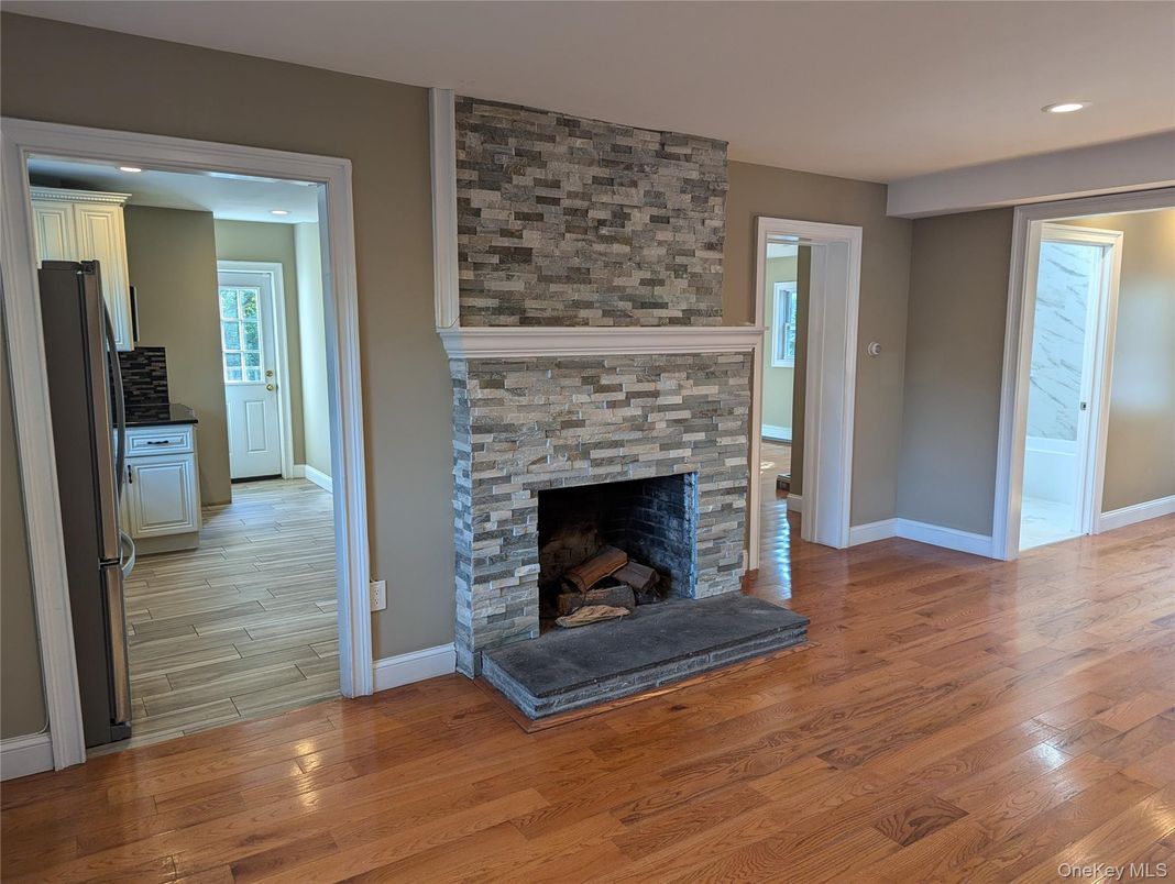 Empty room, Fireplace, Interior, Recessed Lighting, Stone Walls, Wood Texture Flooring