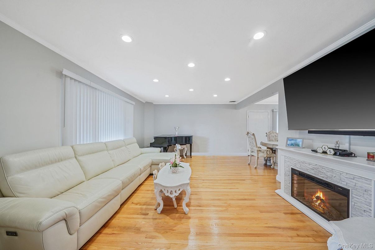 Dining room, Fireplace, Interior, Living room, Piano, Recessed Lighting, Wood Texture Flooring