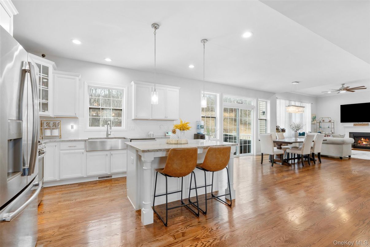 Dining room, Fireplace, Interior, Kitchen, Pendant Lights, Recessed Lighting, Stainless Steel Appliances, Wood Texture Flooring
