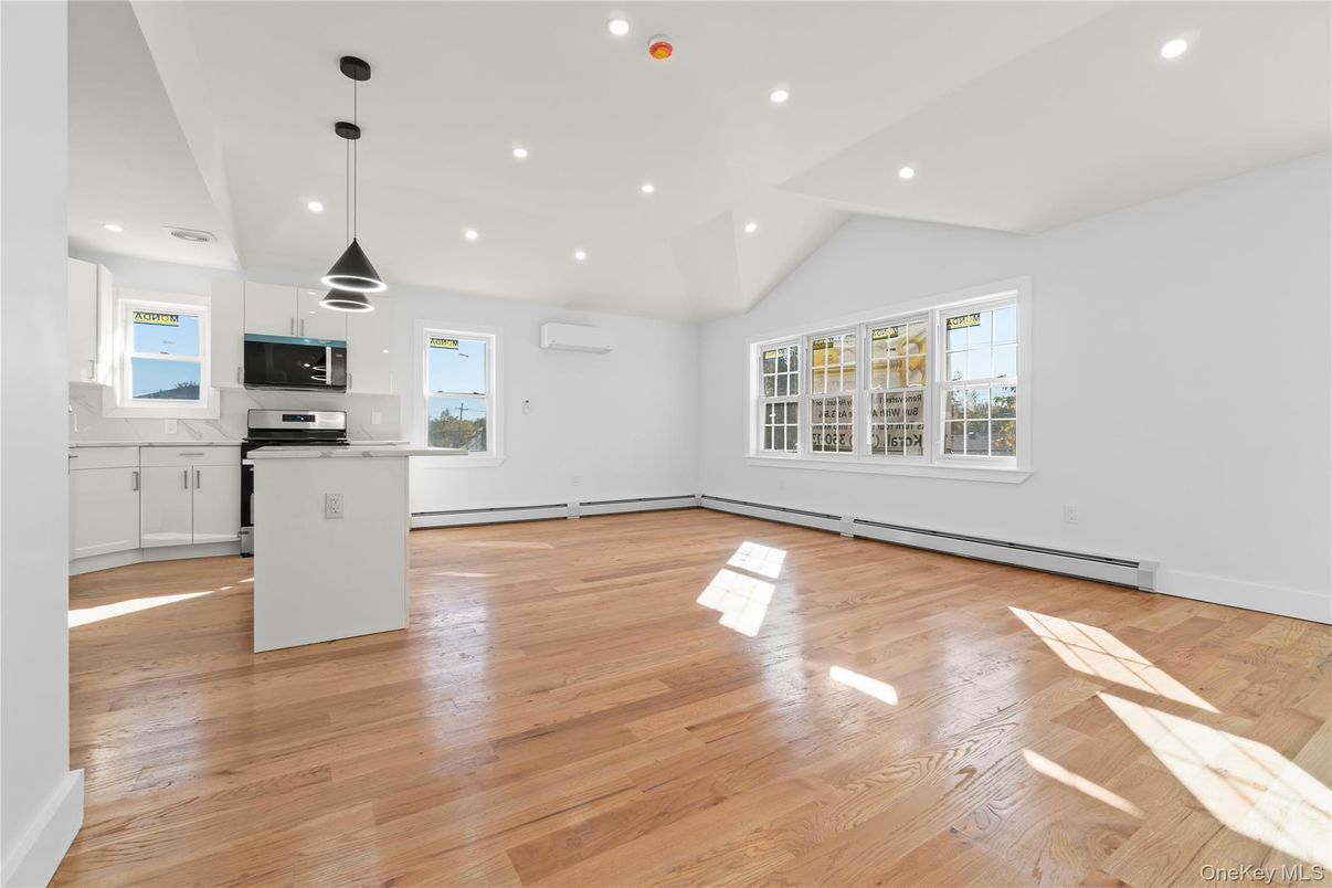 Empty room, Interior, Kitchen, Pendant Lights, Recessed Lighting, Stainless Steel Appliances, Wood Texture Flooring