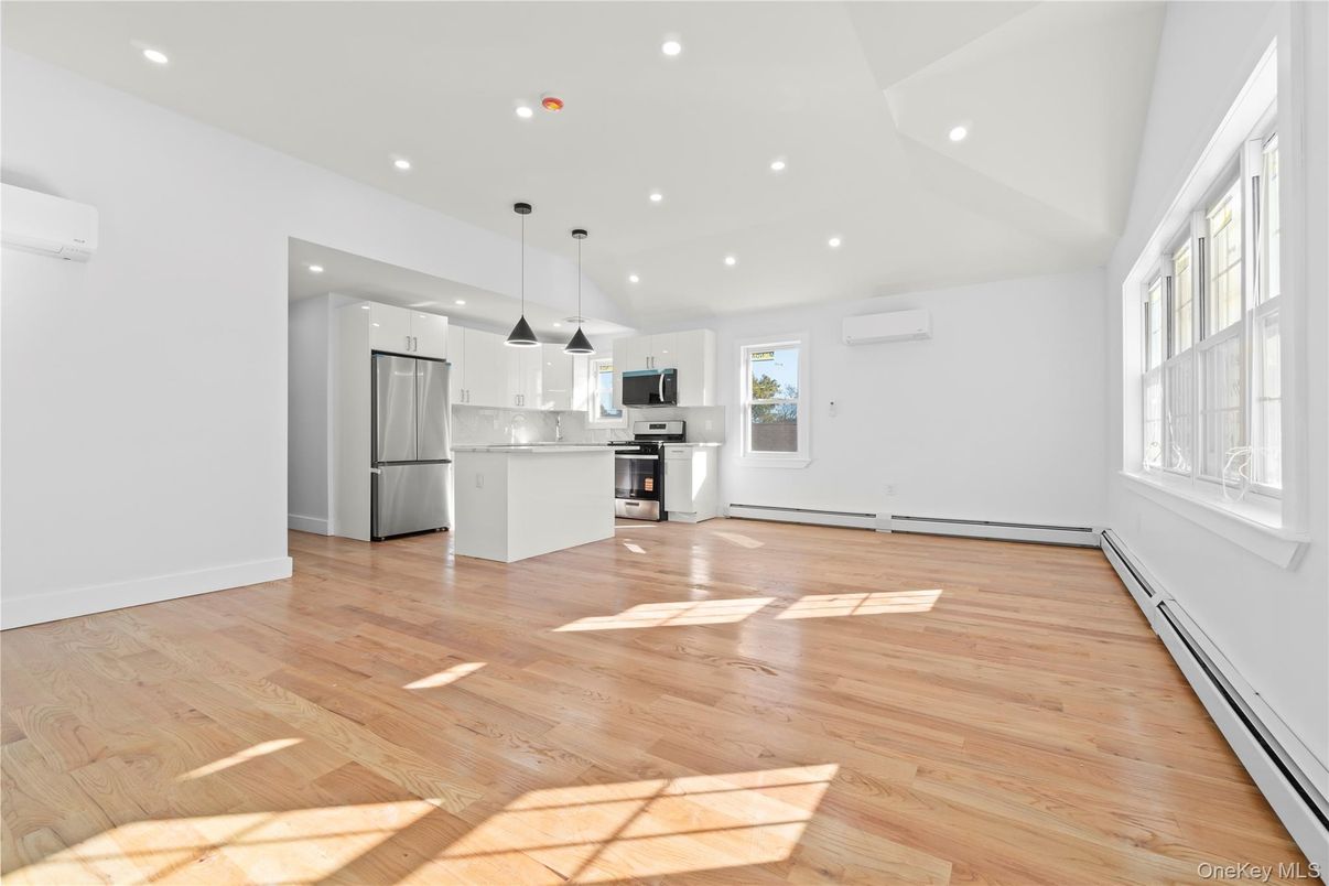Empty room, Interior, Kitchen, Pendant Lights, Recessed Lighting, Stainless Steel Appliances, Wood Texture Flooring