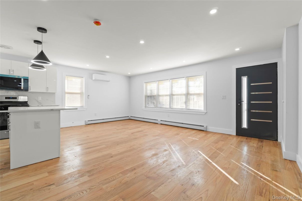 Empty room, Interior, Kitchen, Pendant Lights, Recessed Lighting, Stainless Steel Appliances, Wood Texture Flooring