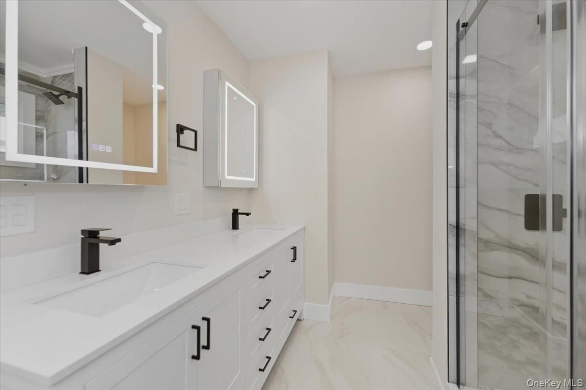 Bathroom, Dual Sink Vanities, Glass Shower, Interior, Marble, Marble Walls, Recessed Lighting